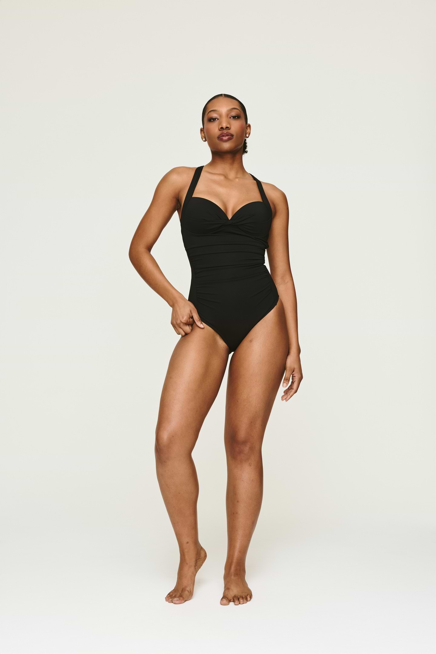 Shekina Lee posing in a black swimsuit