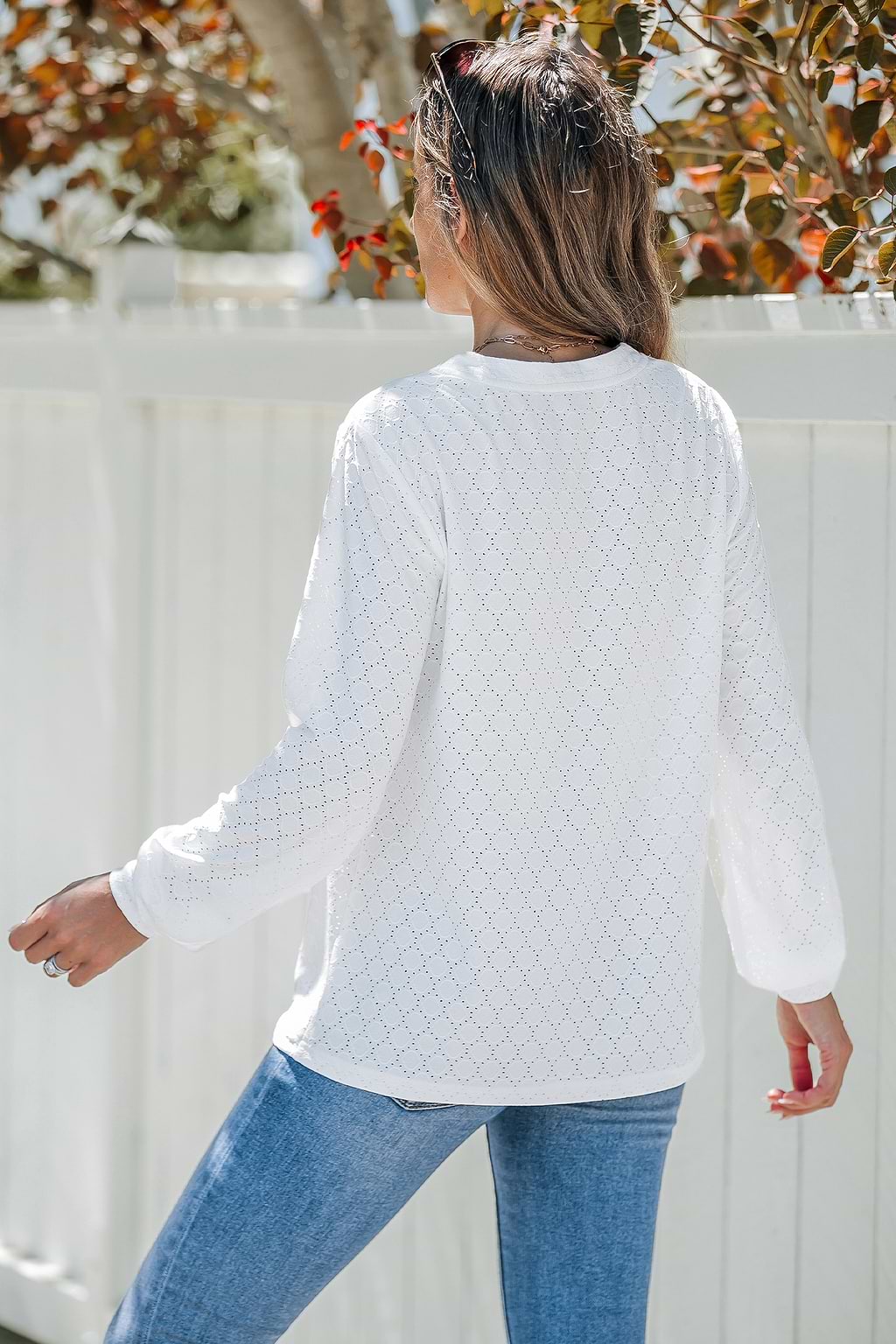 Witte top met lange mouwen en knopen aan de voorkant van jersey